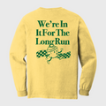 Yellow long-sleeve shirt with green text and graphic on a light gray background