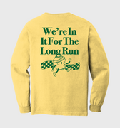 Yellow long-sleeve shirt with green text and graphic on a light gray background