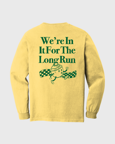 Yellow long-sleeve shirt with green text and graphic on a light gray background