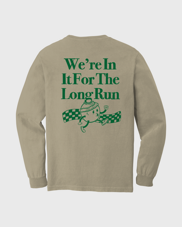 Beige long-sleeve shirt with green text and graphic on a white background