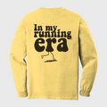 Yellow long-sleeve shirt with 'In my running era' text and graphic 