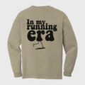 Beige long-sleeve shirt with 'In my running era' text and graphic