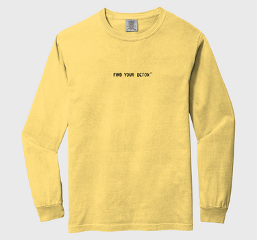 Yellow long-sleeve shirt with text on a light gray background