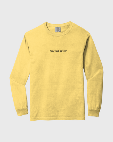 Yellow long-sleeve shirt with text on a light gray background